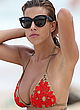 Devin Brugman busty in red bikini at a beach pics