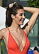 Chloe Goodman in coral swimsuit on a beach pics