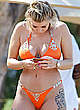 Olivia Buckland in orange bikini on a beach pics