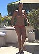 Priscilla Betti topless in hotel backyard pics