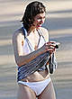 Milla Jovovich on the beach in white bikini pics