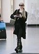 Anya Taylor-Joy black coat and knee-high boots pics