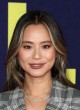 Jamie Chung posing in a chic gray pantsuit pics