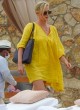 Charlize Theron stuns in a yellow swimsuit pics