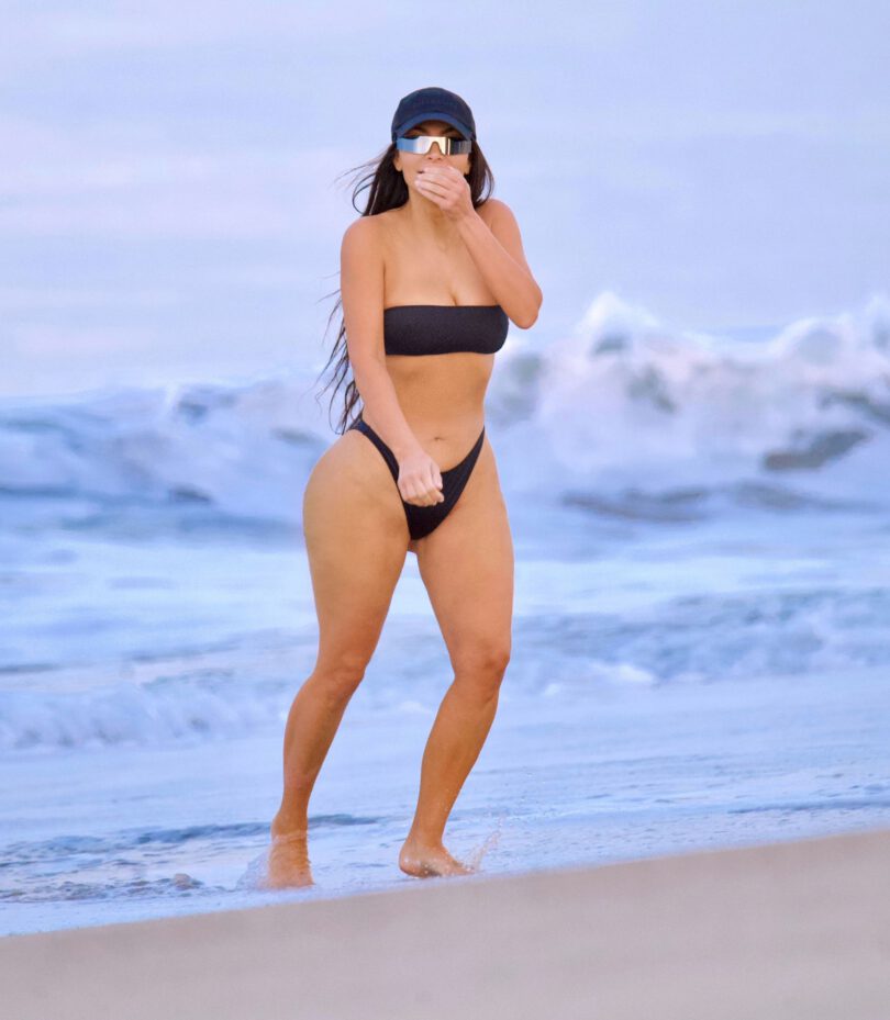 Kim Kardashian Shows Off Her Famous Curves in a Black Thong Bikini at the Beach in Malibu pics